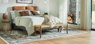Person sitting on white area rug in living room